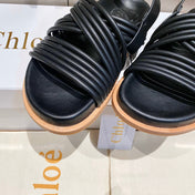 CROSS STRAP SANDAL IN BLACK RUBBER WITH GOLD HARDWARE