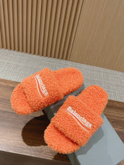FURRY SLIDES IN ORANGE CURLY SHEARLING