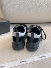 CHANEL 25S TRAINERS 40MM IN BLACK AND WHITE CALFSKIN AND SUEDE