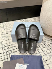 PRADA 25S RUBBER SLIDE IN BLACK CALFSKIN WITH LOGO