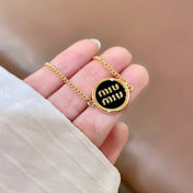 MIUMIU 26S LOGO ROUND BRACELET IN BLACK ENAMEL AND GOLD TONE METAL 631809
