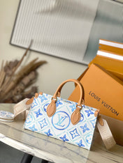 ONTHEGO EAST WEST 25 IN LAGOON BLUE MONOGRAM TILES CANVAS