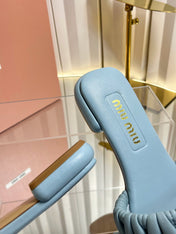 MIUMIU 26S MATELASSE SLIDES IN LIGHT BLUE CALFSKIN GOLD HARDWARE