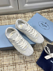 PRADA 26S LOW TOP SNEAKERS IN WHITE NYLON AND SUEDE