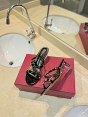 ROCKSTUD MULE SANDALS IN BLACK CALFSKIN AND TRANSPARENT PVC FILM